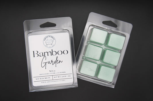 Wax melts in packaging labeled 'Bamboo Garden' on a dark background