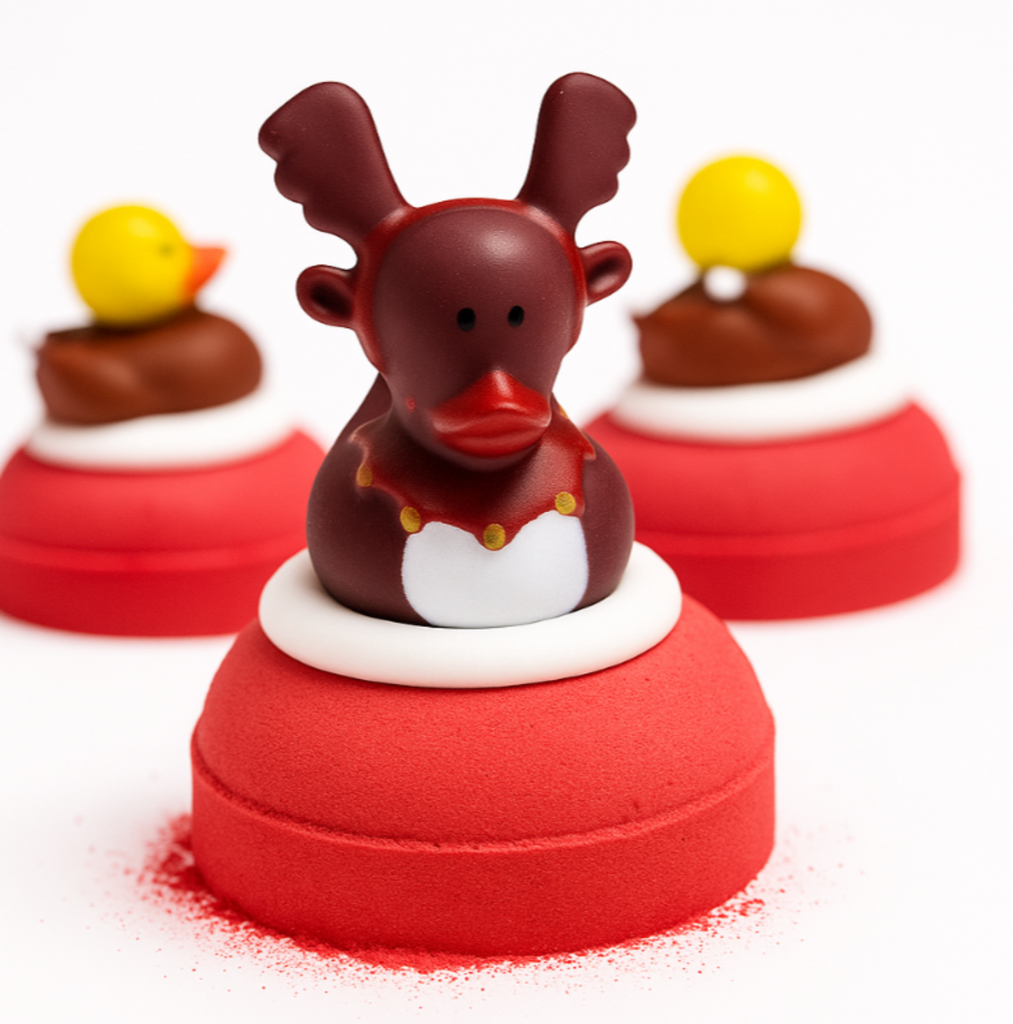 Reindeer duck with red nose on a  red bath bomb on a white background