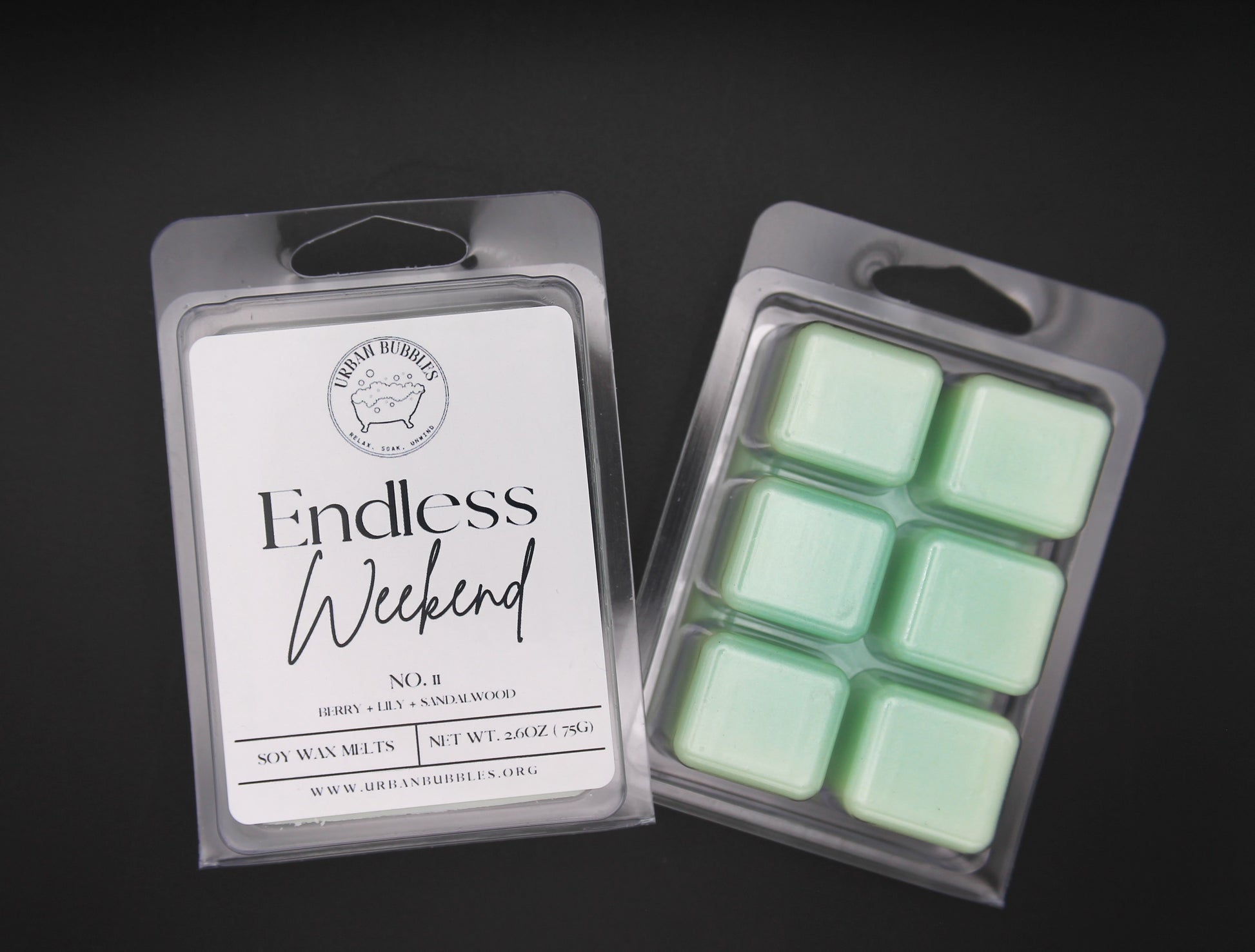 Packaged green wax melts with a label on a dark background