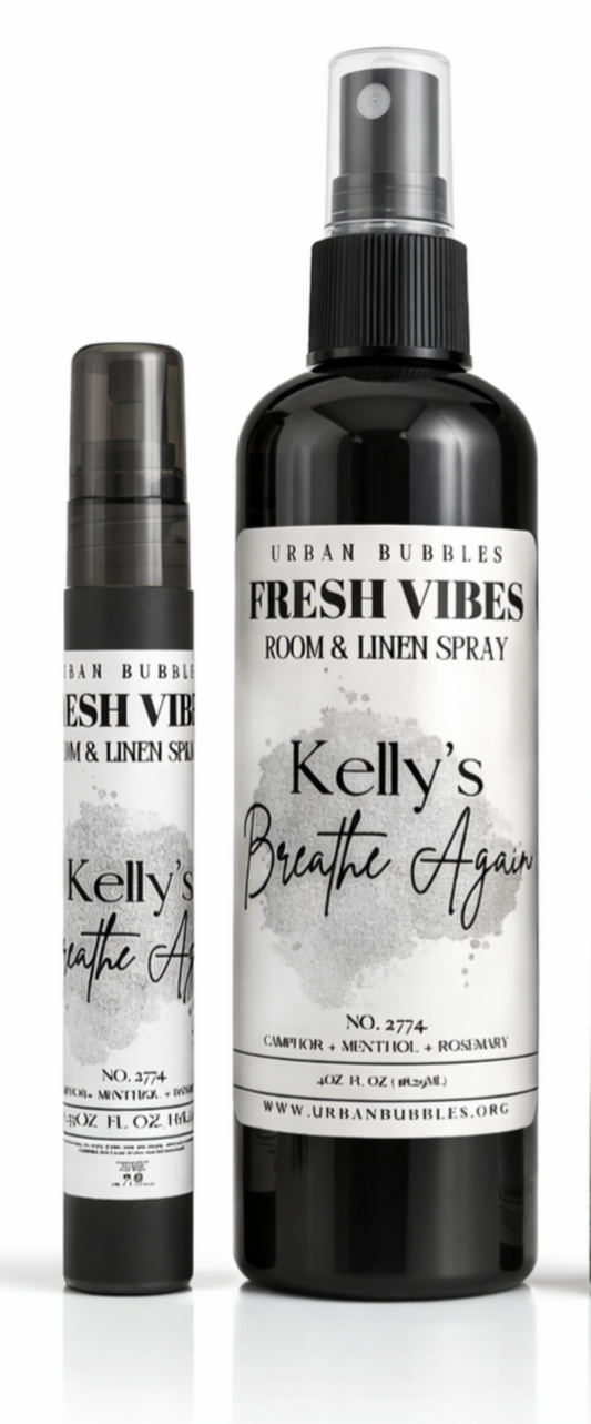 Two bottles of 'Kelly's Breathe Again' room and linen spray with labels on a white background.