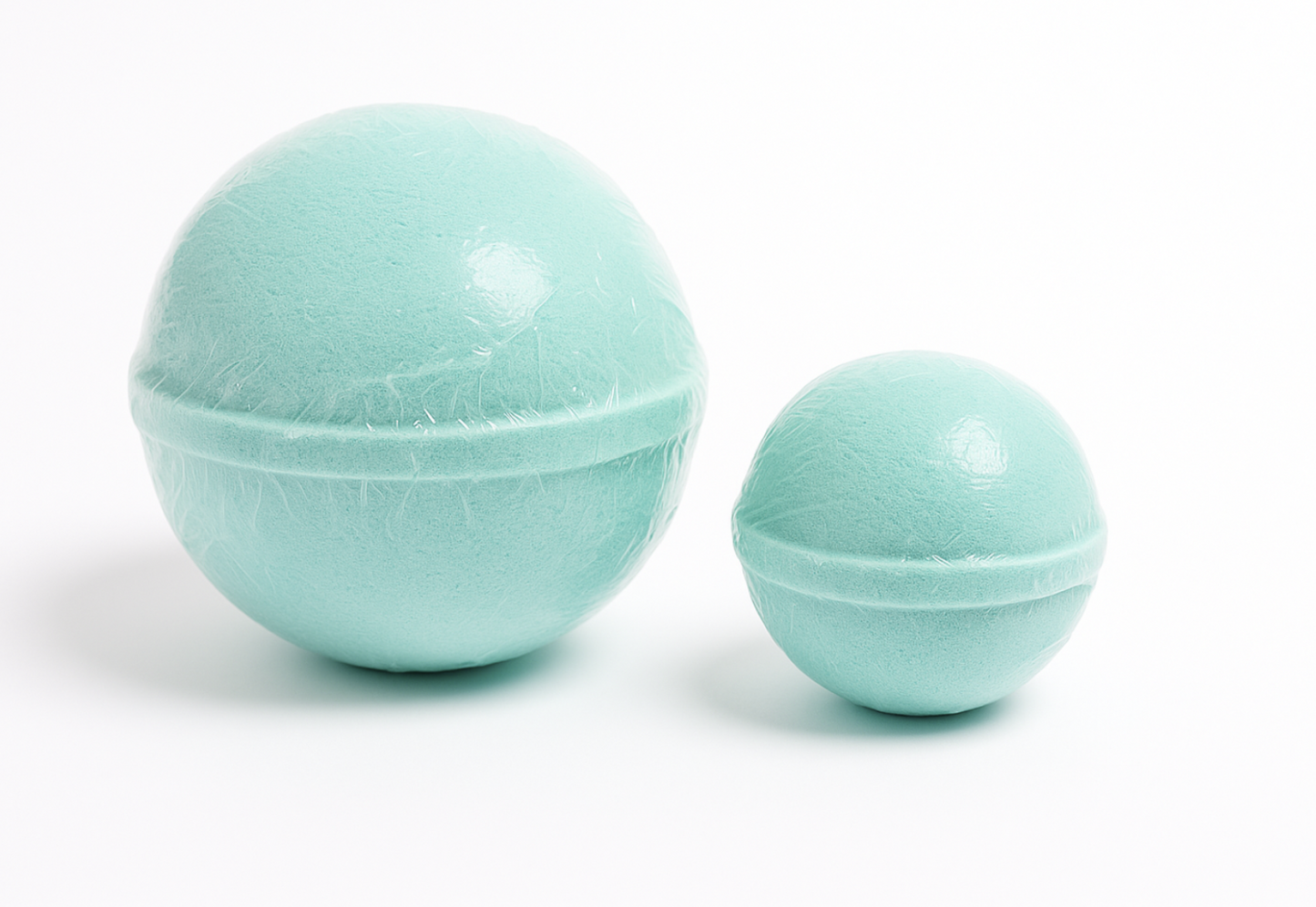 Two turquoise bath bombs on a white background