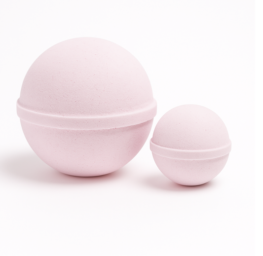 Two pink bath bombs on a white background
