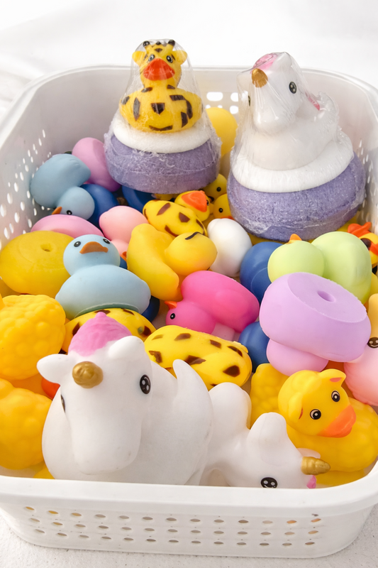 Assorted colorful rubber duckies in a white basket on a white background